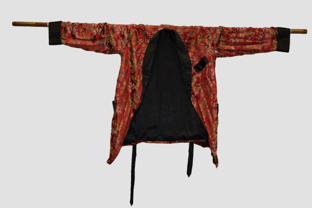 Two Chinese silk brocade jackets, second half 20th century, one red silk with black satin collar,