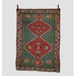 Good Kazak green ground twin medallion rug, south west Caucasus, circa 1910-1920s, 5ft. 9in. X