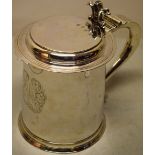 A William III silver three pint tankard, engraved a plumed armorial shield, the hinged rounded lid