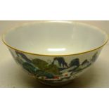 A Chinese porcelain famille verte bowl, decorated buildings, a tree and boulders in a landscape,