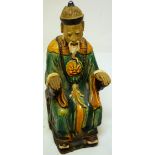 A late nineteenth century Chinese pottery figure of a seated dignatory, wearing a green robe, 9.