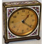 A German Kienzel brass and cloisonne decorated boudoir alarm clock, with a circular dial, on bun