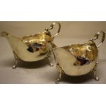 A pair of eighteenth century Irish silver oval sauceboats, with fret outline rims, cast leaf