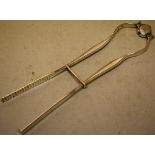 A pair of George III silver asparagus tongs, the central sprung pivot engraved a cannon crest,