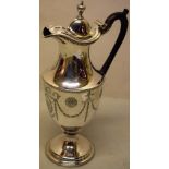 A George III silver wine jug, the vase shape body engraved bellflower swags united by anthemion