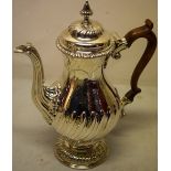 A late George II silver vase shape coffee pot, part swirl fluted and ribbed, engraved rococo foliage