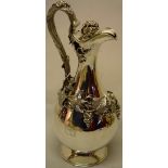 A Victorian silver wine jug, the baluster body engraved one side with a crest and motto, applied