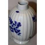 A Continental porcelain tea vase, the ribbed ovoid body painted sprays and sprigs of blue flowers,