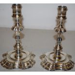 A Royal pair of George II cast silver candlesticks, the campana shape candleholders with a girdle