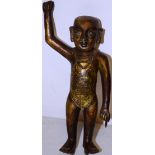 A Burmese gilt bronze temple votive figure, of a Buddhist boy monk, holding up his right arm (