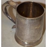 A George 1st Britannia standard silver mug, with a hollow capped scroll handle, engraved initials