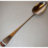 A large George III silver stuffing spoon, Old English Pattern, engraved a headless fish crest, 14.