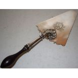 A George II silver slice, the triangular blade engraved a contemporary armorial in a rococo