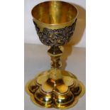 A mid eighteenth century German silver gilt chalice, the bowl with a pierced fruiting foliage sleeve