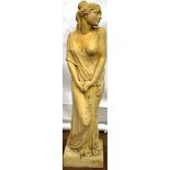 A coad stone statuette of Vestal Virgin looking over her left shoulder, clutching a branch of