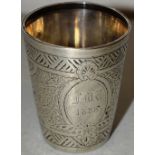 A Victorian silver childs beaker, with engraved patterned tapering sides, the oval cartouche with