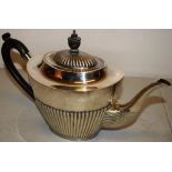 An Edwardian oval silver teapot, partly ribbed Queen Anne pattern, with swan neck spout, the
