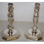A pair of French cast silver candlesticks chased in the Louis XIV classical manner, the knopped