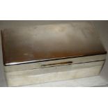 A rectangular silver cigarette box, the hinged lid engine turned, the interior gilded with a lining,