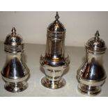 Three mid eighteenth century silver baluster muffineers, one crested, with pierced detachable