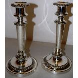 A pair of George IV circular silver candlesticks, the campana shape candleholders with detachable