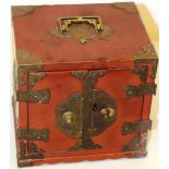 A Japanese red lacquer small table cabinet, with brass hinges and escutcheons, a key bracket handle,