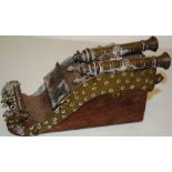A nineteenth century Indian miniature mogul bronze double barrelled cannon, mounted on hardwood