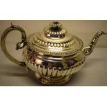 A George IV Scottish silver teapot, the partly ribbed circular body with a presentation inscription,