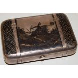 A late nineteenth century Russian silver and Niello decorated cigarette case of trunk form, the