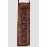 Narrow Kashan runner, west Persia, circa 1950s, 5ft. 11in. X 1ft. 9in. 1.80m. X 0.54m. Mid-blue