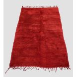 Plain red carpet by the Berbers of Morocco, mid-20th century, 9ft. X 5ft. 10in. 2.75m. X 1.78m. Long