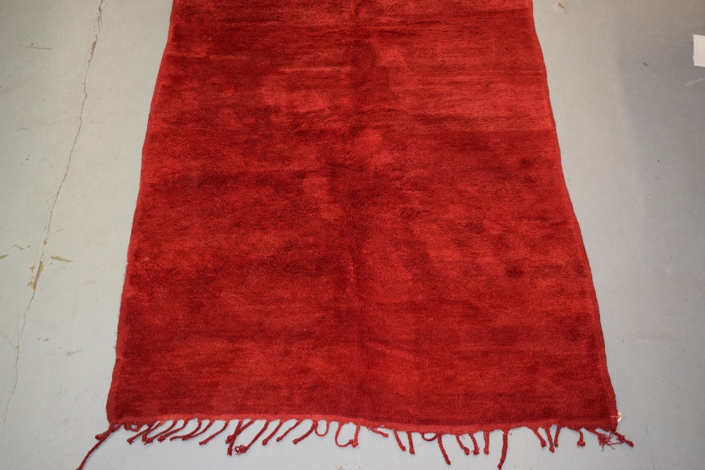 Plain red carpet by the Berbers of Morocco, mid-20th century, 9ft. X 5ft. 10in. 2.75m. X 1.78m. Long - Image 7 of 8