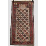 Three rugs, all early 20th century, the first Baluchi prayer rug, Khorasan, north east Persia,