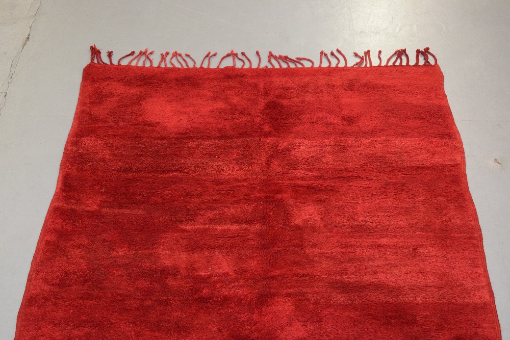 Plain red carpet by the Berbers of Morocco, mid-20th century, 9ft. X 5ft. 10in. 2.75m. X 1.78m. Long - Image 6 of 8