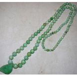 An Eastern jade bead necklace with pendant, approx. 28in (71cm) boxed by Imrie & Lawrence Lahore and