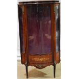 A French mahogany veneered corner vitrine with chased brass mounts, a serpentine front glazed