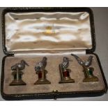 An unusual set of four George V silver and silver gilt game bird menu holders, two plinth with green