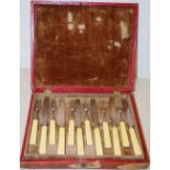 A set of twelve pairs of George IV silver dessert knives and dessert forks, with ivory handles,