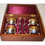 A set of four Victorian circular silver salts, gilded inside on ball feet, with four matching salt