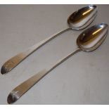 A pair of late eighteenth century Irish silver basting spoons, the tapering ends engraved a plant