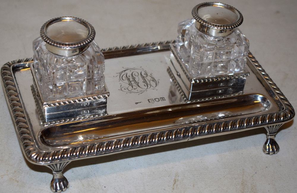 A late Victorian rectangular silver inkstand, fitted two cut glass ink pots, with hinged silver