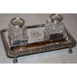 A late Victorian rectangular silver inkstand, fitted two cut glass ink pots, with hinged silver