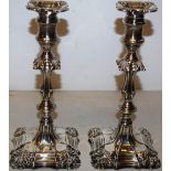 A pair of late Victorian/Edwardian silver candlesticks, the spool shape candleholders with