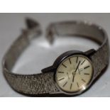 A ladies Omega de Ville wrist watch, with textured silver plated strap.