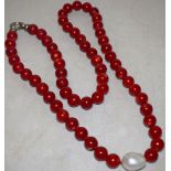 A bamboo bean coral necklace with a mother of pearl drop pendant, a metal ring clasp, 3ft 1in (