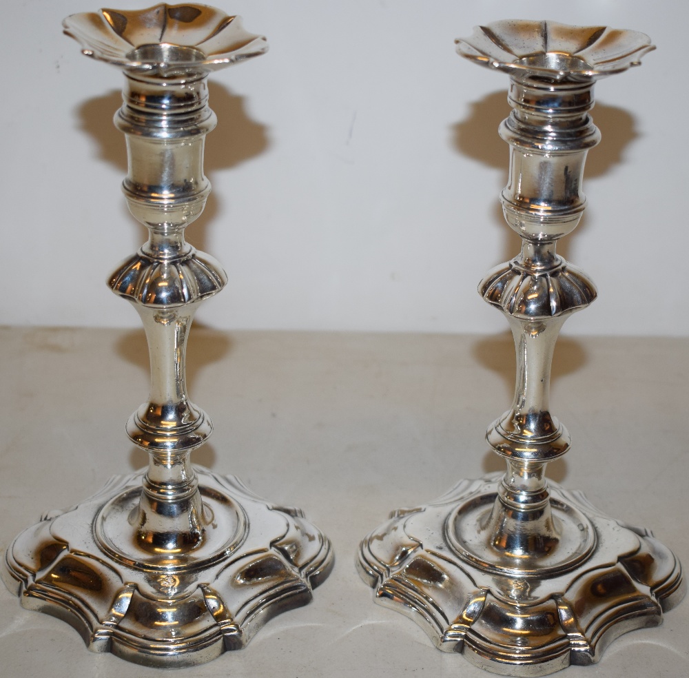 A pair of George II cast silver candlesticks, matching the previous lot, with nozzle extensions,