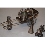 A Chinese silver coloured metal rickshaw condiment set, 7.75in (19.5cm) (early twentieth century