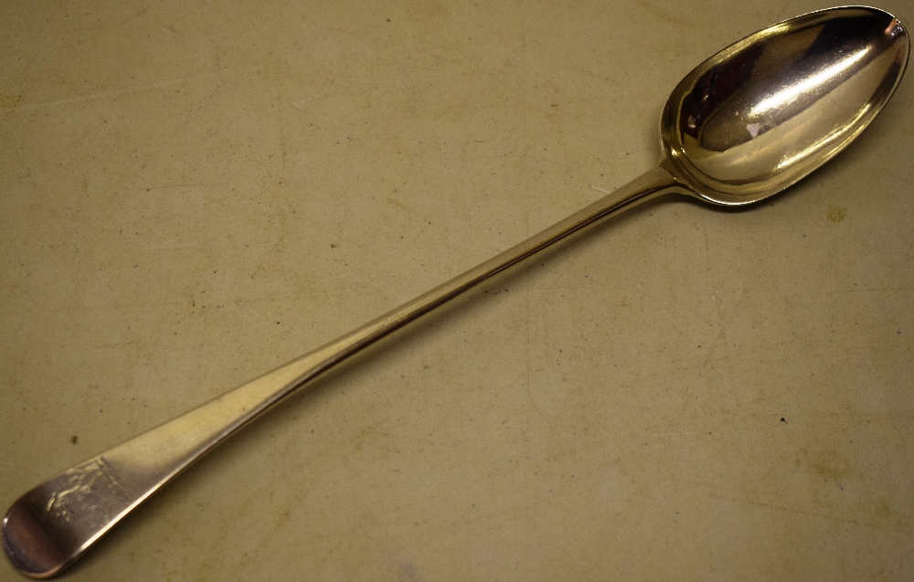 An early George III silver provincial basting spoon, Old English pattern, rampant lion crest,