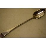 An early George III silver provincial basting spoon, Old English pattern, rampant lion crest,