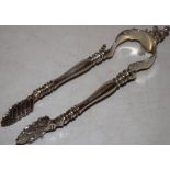 A pair of Victorian silver ice tongs of andiron form, the top with a cast imbibing figure seated